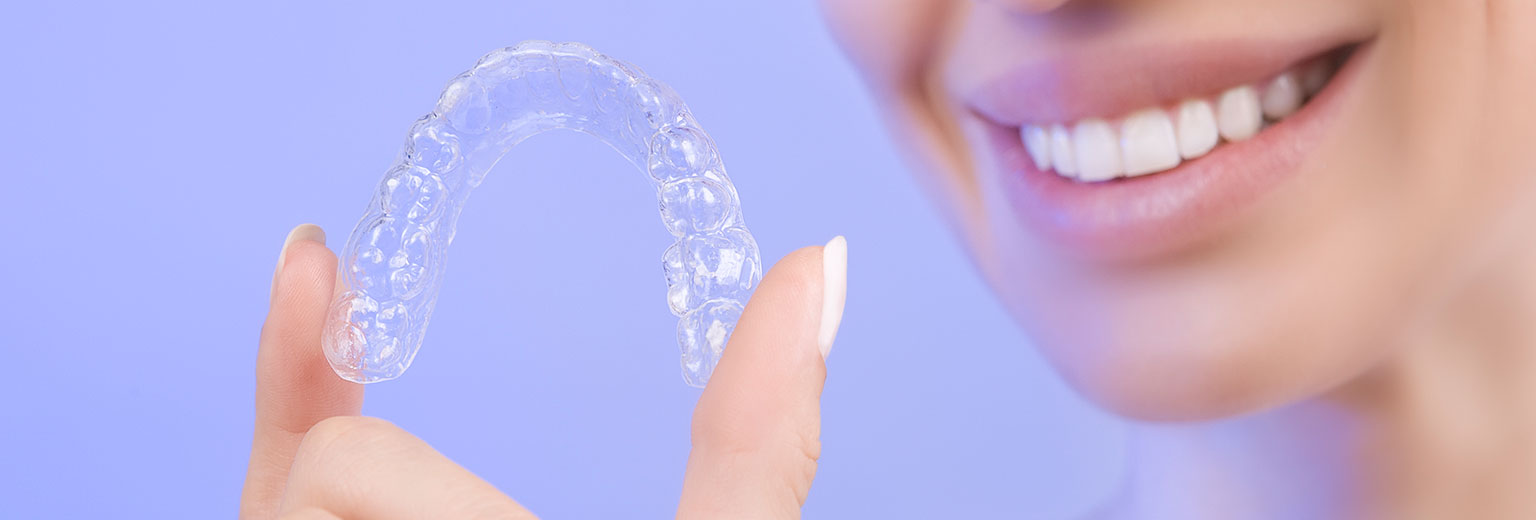 Lady holding an invisalign
